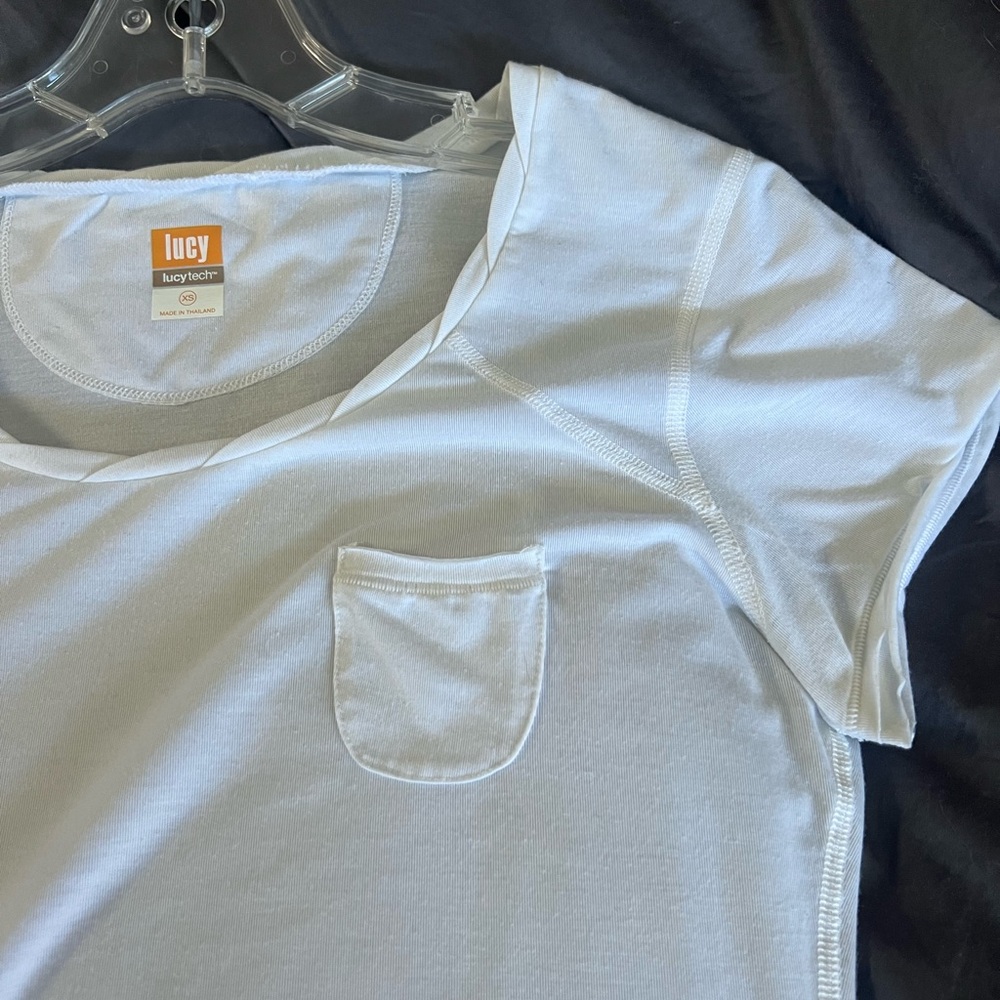 White Lucy brand teeshirt with detail around the neck. Size XS